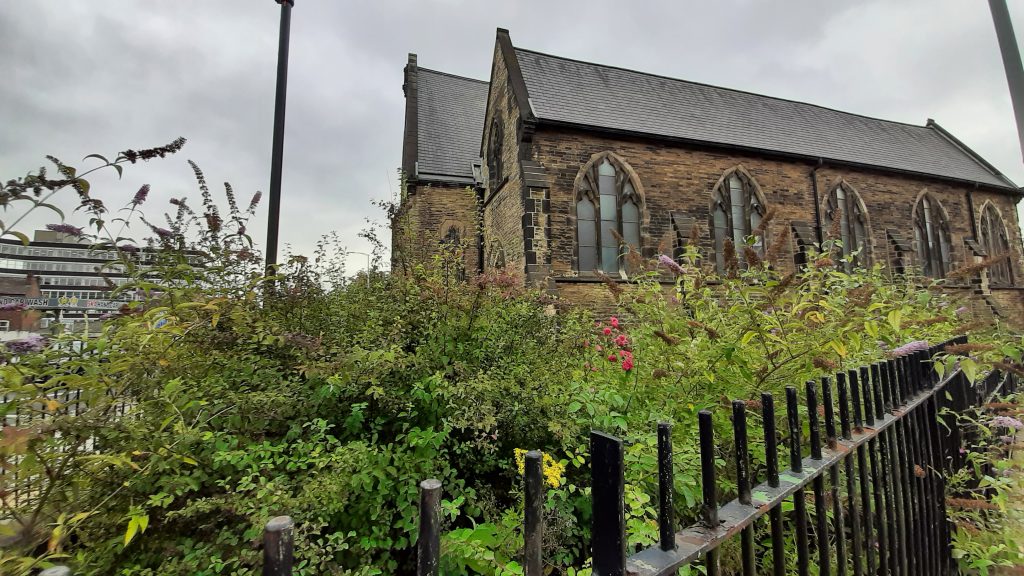 View from the corner of Wellington Road North and George's Road. Weeds are level with and above the railings