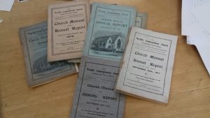 Collection of annual booklets, one with the etching in the middle of the cover.