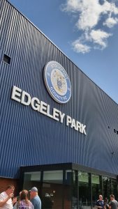 The Blue frontage of Edgeley Park with the large round logo